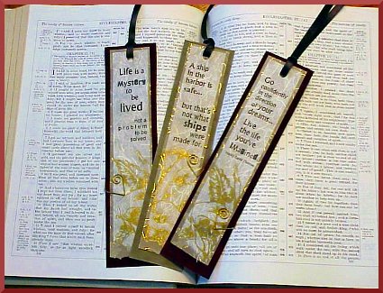 Gold lily embossed paper bookmarks.