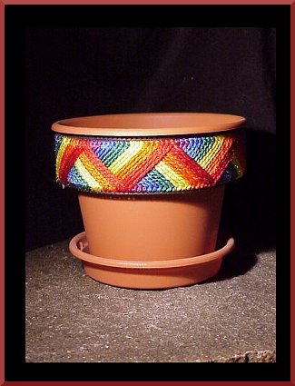 A decorative collar for flower pots stitched on plastic canvas.